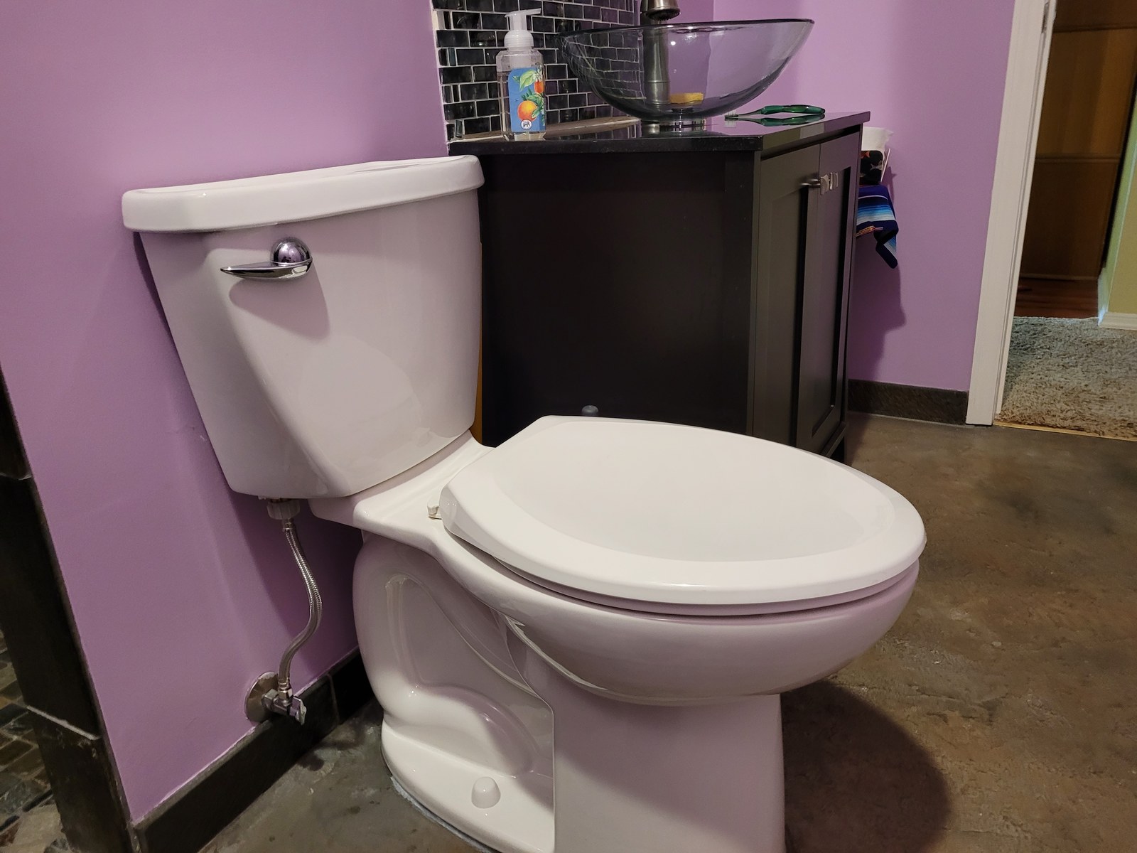 Rebuilt two-piece toilet reassembled with the tank lid back on